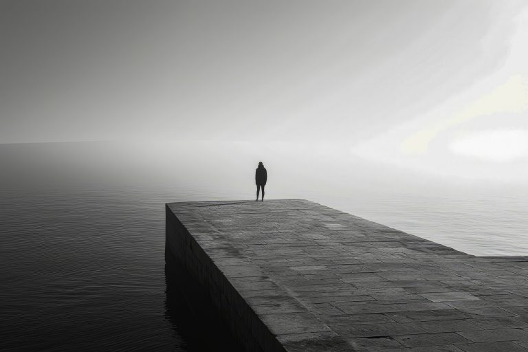 Person is standing on dock in the water
