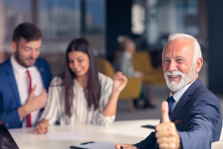 Positive aged couple consulting with insurance agent